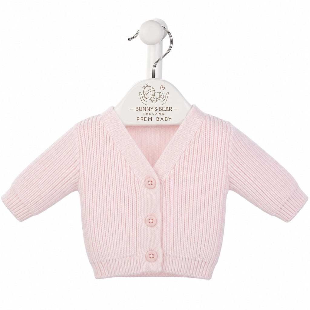 A light pink ribbed knit baby cardigan sweater with three buttons, displayed on a white hanger with the brand name 'Bunny's Bear - Prem Baby' printed on it, against a plain white background.