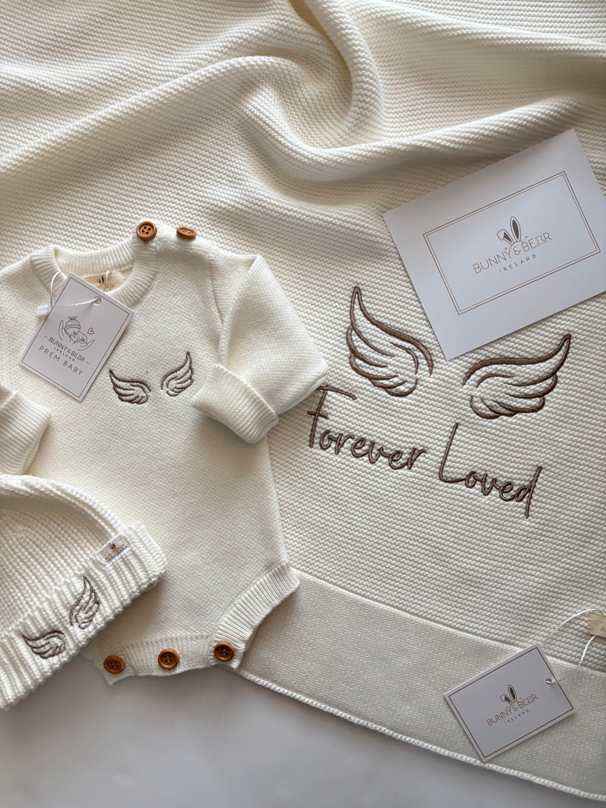 cotton baby knit ivory romper, hat and blanket featuring angel wings to recognize infant loss
